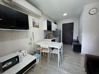a kitchen with a white table and chairs in a room at Royal Lee Condo in Ban Bo Han