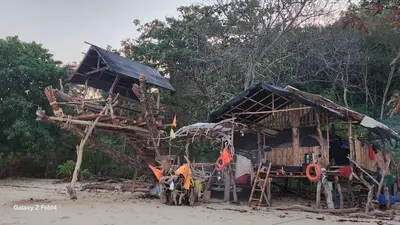 a small hut on the beach next to trees at Naturist Beach Camping Private Beach Phuket in Ko Lone