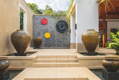 a lobby with three large vases on a wall at Villa 7 Miramare Andara Signature - The Most Exclusive Villa in Phuket in Amphoe Thalang