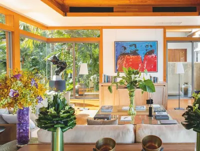 a living room with a couch and a table with flowers at Villa 7 Miramare Andara Signature - The Most Exclusive Villa in Phuket in Amphoe Thalang