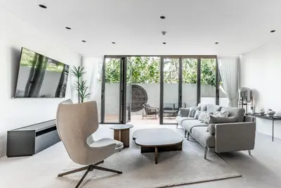 a living room with a couch and a chair at Bluepoint by Villacarte in Patong Beach