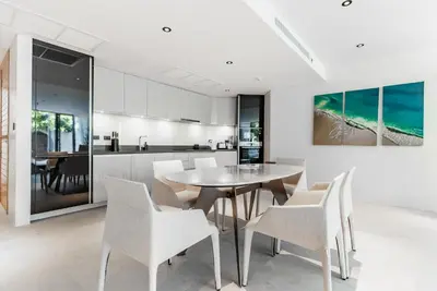 a kitchen and dining room with a table and chairs at Bluepoint by Villacarte in Patong Beach