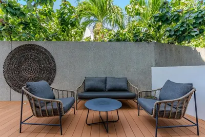 two chairs and a table on a patio at Bluepoint by Villacarte in Patong Beach