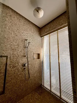 a bathroom with a shower and a window at Bang Tao Anchan Flora 3 bd in Ban Phru Champa