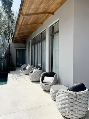 a row of chairs sitting on a patio at Bang Tao Anchan Flora 3 bd in Ban Phru Champa