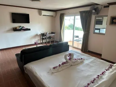 a bedroom with a bed with a heart decoration on it at Taj Palace Patong Beach in Patong Beach