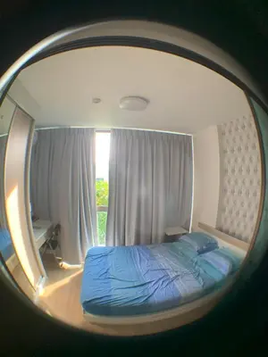 a reflection of a bed in a round mirror at Beautiful space in Ban Sam Kong