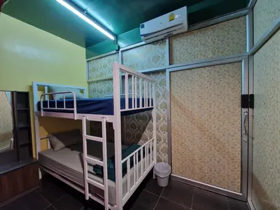 a bunk bed room with two bunk beds in it at Bonanza Patong Beach II Red Room in Patong Beach