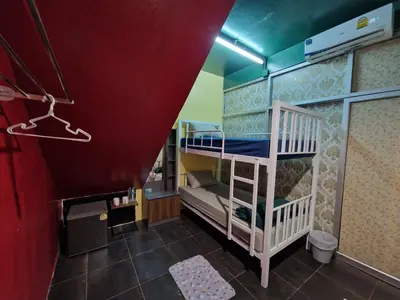 a room with two bunk beds and a red ceiling at Bonanza Patong Beach II Red Room in Patong Beach