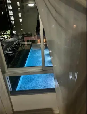 a view of a swimming pool in a building at Lux Center Apartment in Kathu