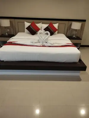a large bed with two white swans on it at Sumer guesthouses in Patong Beach