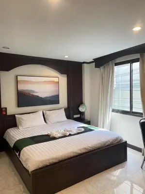 a bedroom with a large bed in a room at Sumer guesthouses in Patong Beach