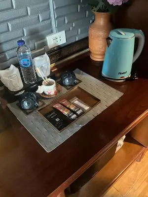 a table with a tray of food and a coffee maker at Sumer guesthouses in Patong Beach