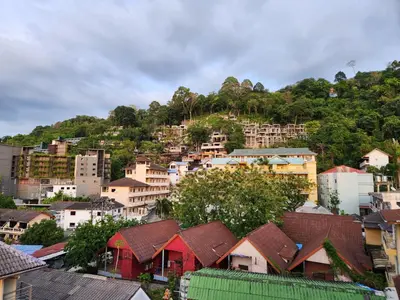 a group of houses on a hill with a city at Sunshine Guesthouse Nanai Patong in Patong Beach