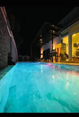 a large blue swimming pool at night at Skylight Nice Pool Villa in Kamala in Kamala Beach