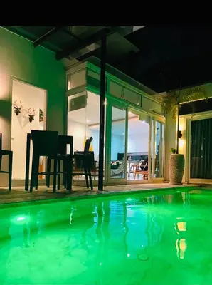 a house with a swimming pool with a table and chairs at Skylight Nice Pool Villa in Kamala in Kamala Beach