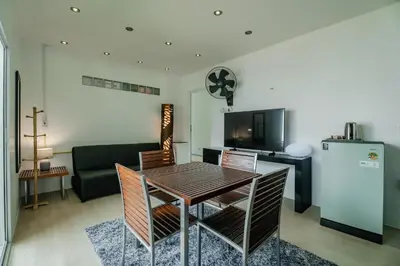 a living room with a table and a couch at Skyfall Private Pool Villa In Rawai in Rawai Beach