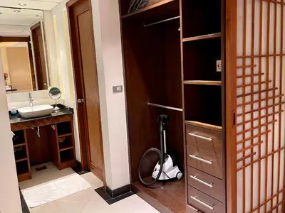 a bathroom with a scooter parked in front of a mirror at Kata Seaview Serenity - Luxury 1BR Apartment in Karon Beach