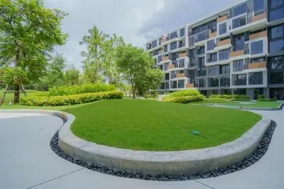 a large grassy area in front of a building at Skypark by Villacarte in Laguna Phuket