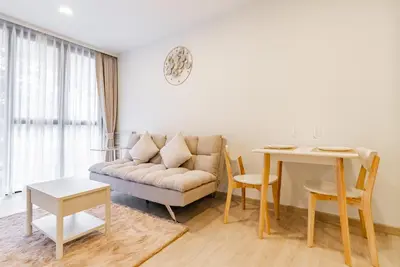 a living room with a couch and a table at Skypark by Villacarte in Laguna Phuket