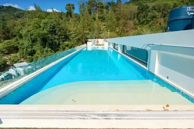 a swimming pool on the roof of a building at New 1BDR Fantasea Kamala beach in Kamala Beach