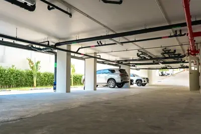 an empty parking garage with a car parked in it at New 1BDR Fantasea Kamala beach in Kamala Beach