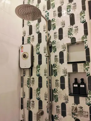 a shower in a bathroom with a shower curtain at Baannira บ้านนิรา in Ban Sam Kong