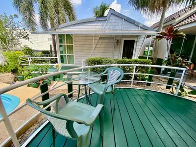 a deck with chairs and a table on a house at 2 Bedrooms House with Private Pool the heart of rawai in Ban Saiyuan (1)