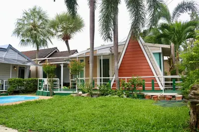 a house with a triangular roof and palm trees at 2 Bedrooms House with Private Pool the heart of rawai in Ban Saiyuan (1)