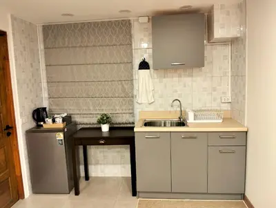 a kitchen with a sink and a counter top at Baannira บ้านนิรา in Ban Sam Kong