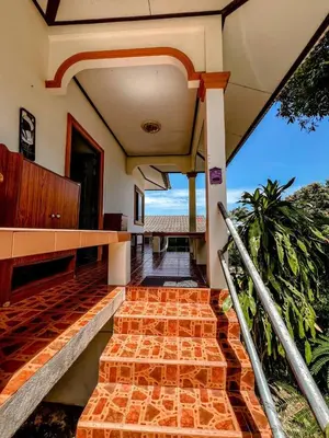 a house with a staircase with a view of the ocean at Sea House in Panwa in Ban Lo Long