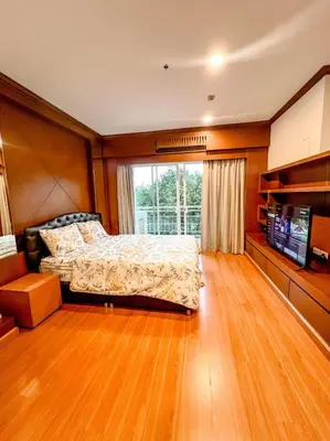 a bedroom with a bed and a large window at Green Place in Phuket Town