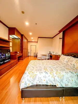 a large bedroom with a large bed and a kitchen at Green Place in Phuket Town