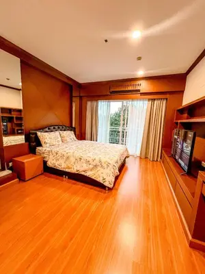 a bedroom with a bed and a large window at Green Place in Phuket Town