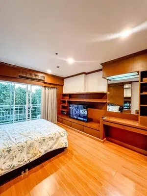 a bedroom with a bed and a large window at Green Place in Phuket Town