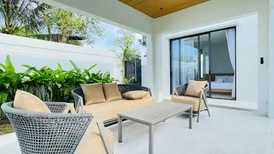 a patio with a couch and chairs and a table at Mouana Residence Song Khun Chalong 8910 in Phuket Town