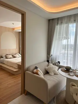 a living room with a couch and a bed at Fantasea Condo Kamala in Kamala Beach
