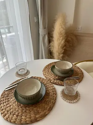 a white table with two plates and bowls on it at Fantasea Condo Kamala in Kamala Beach