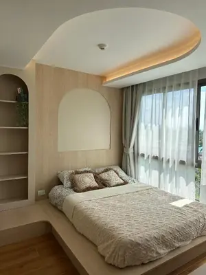 a bedroom with a large bed and a large window at Fantasea Condo Kamala in Kamala Beach