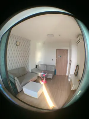 a living room with a couch and a table at Fab condo in Ban Tha Khreng