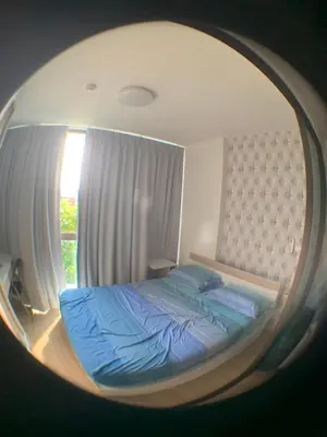 a bedroom with a bed in a round mirror at Fab condo in Ban Tha Khreng