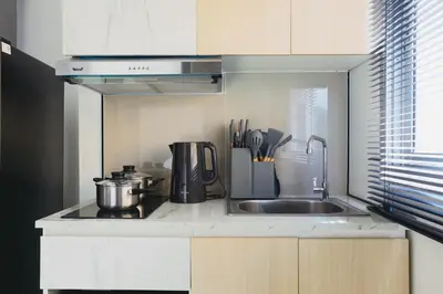 a kitchen with a sink and a counter top at Wink City 4 Patong Phuket in Patong Beach