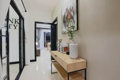 a hallway with a table with a vase on it at Wink City 4 Patong Phuket in Patong Beach