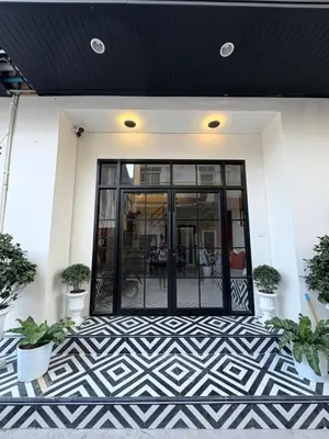 an entrance to a building with a black and white floor at Wink City 4 Patong Phuket in Patong Beach