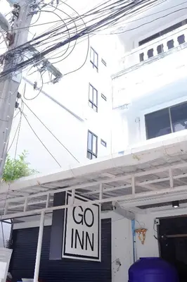 a sign that says go inn hanging in front of a building at XX GO INN Patong Beach in Patong Beach