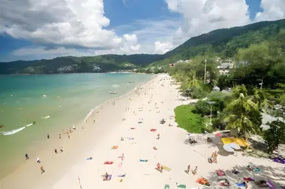 a group of people on a beach in the water at XX GO INN Patong Beach in Patong Beach
