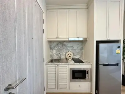 a dog is sitting on a counter in a kitchen at DLUX 7TH Floor in Ban Klang