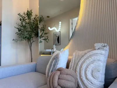 a living room with a couch with pillows at DLUX 7TH Floor in Ban Klang