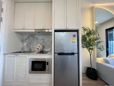 a kitchen with a refrigerator and a microwave at DLUX 7TH Floor in Ban Klang