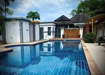a swimming pool in front of a house at Casa Gris with Shared Pool in Ban Bo Han